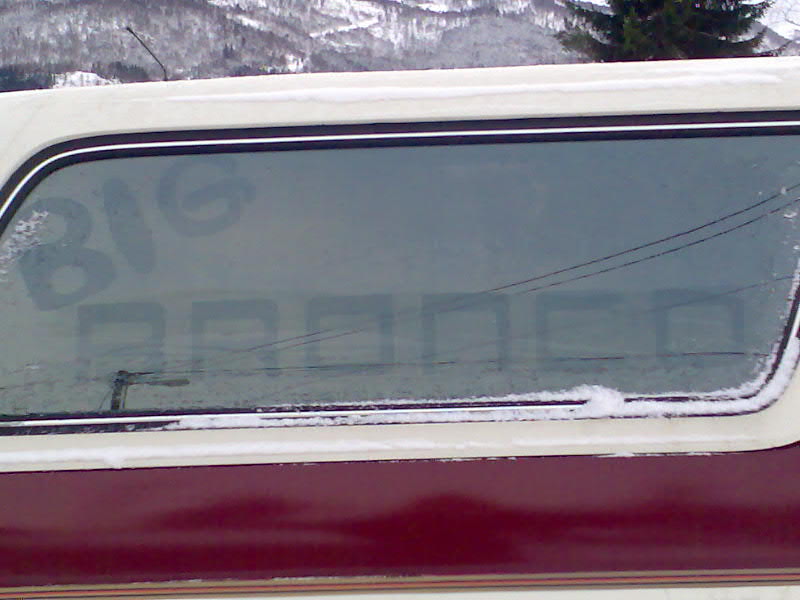 1989 Ford Bronco side window with 'BIG BRONCO' written in the frost, snow on the window frame