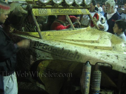 Mud-caked yellow off-road buggy with BFGoodrich decals at night