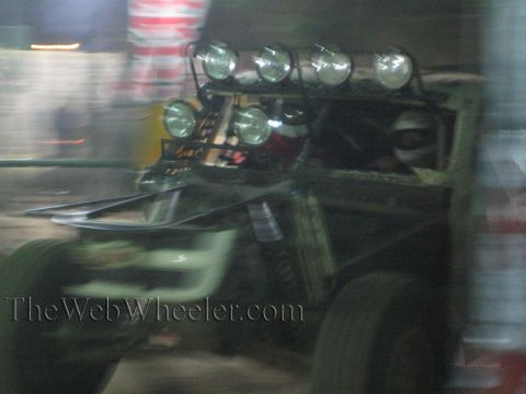 Motion-blurred off-road truck with a bank of roof lights at night