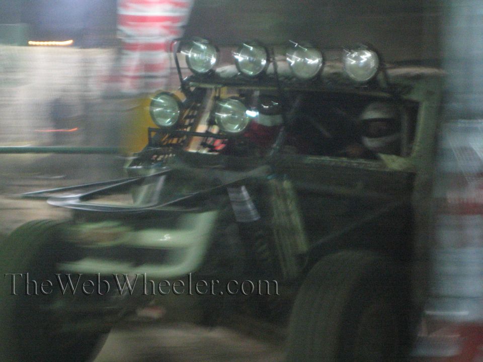 Motion-blurred off-road truck with a bank of roof lights at night