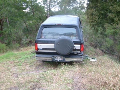 1992 Ford Bronco - Rear view of a 1987-1991 Ford Bronco parked outdoors with a spare tire on the back.