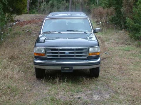 1992 Ford Bronco - This 1992 Ford Bronco is shown from the front, parked outdoors on a grassy lot.