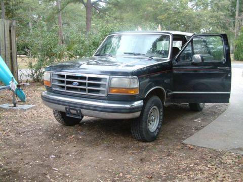 1992 Ford Bronco - This 1992 Ford Bronco is parked outside with the driver's door ajar.