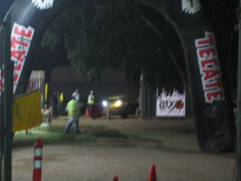 Off-road vehicle with headlights entering a Tecate-arched course