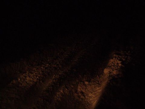 2000 Chevrolet Tahoe - Illuminated rocky terrain at night.