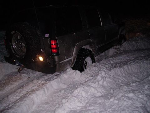 2000 Chevrolet Tahoe - This SUV is stuck in a snowdrift, with its rear tire buried deep in the snow.