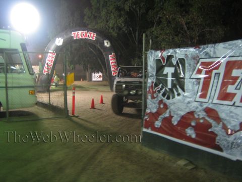 Pickup truck with roof light bar on a dirt course at night