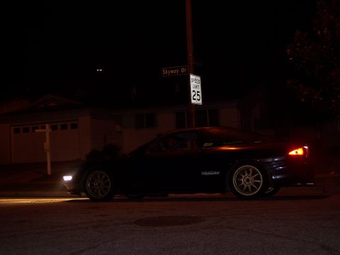 1995 Ford Probe - A dark coupe with custom wheels is seen at night on Skyway Dr.