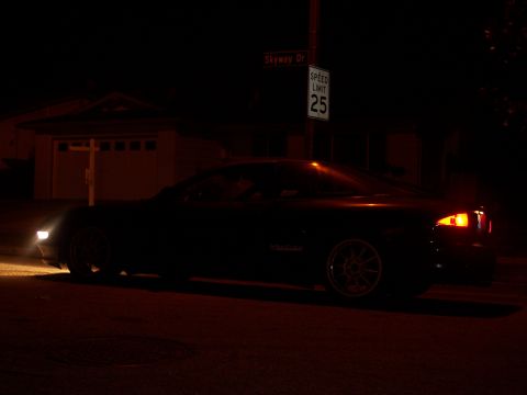 1995 Ford Probe - A dark coupe is seen from the side at night, with its headlights illuminated.