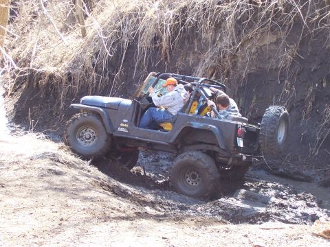 1981 Jeep CJ7 - This 1981 Jeep CJ7 is navigating a challenging off-road course, getting stuck in the mud.