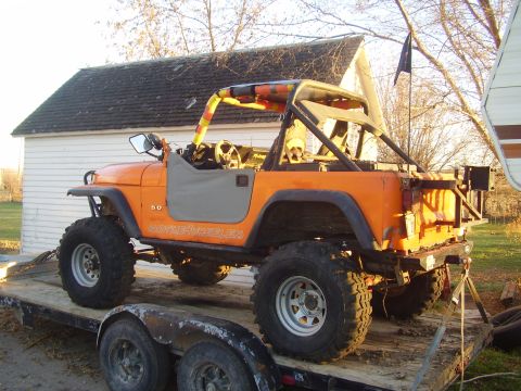1981 Jeep CJ7 - This modified Jeep CJ is loaded onto a trailer, ready for transport.