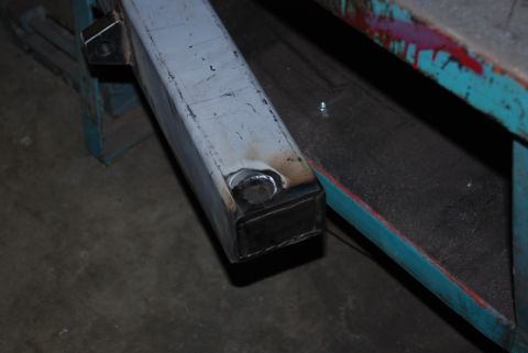 1996 Ford Bronco - A close-up view of a metal tube, likely a custom part, showing welding and a circular insert.