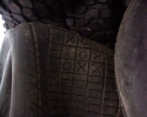 1995 Ford Bronco - A close-up view of a tire tread a unique tic-tac-toe grid pattern.