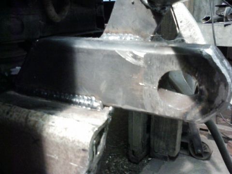 1995 Ford Bronco - A close-up view of a fabricated metal bracket, likely for automotive repair or modification.