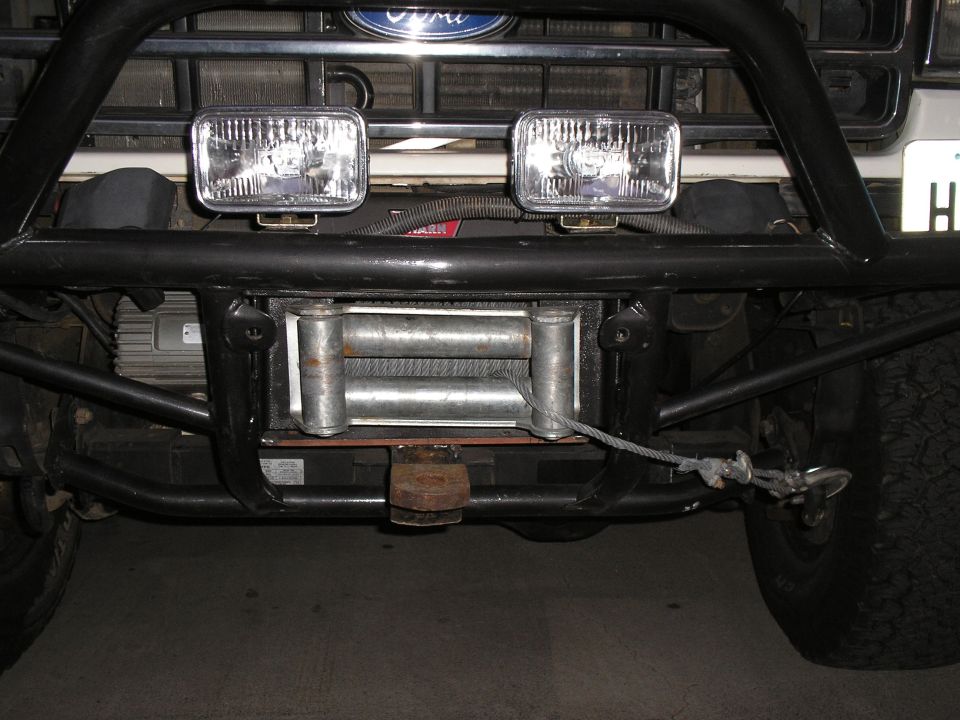 Front winch and driving lights mounted on a tube bumper of a Ford truck