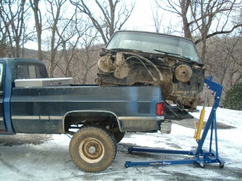 1989 Ford F-250 - An engine hoist is used to remove the front end of a vehicle from the bed of a pickup truck.