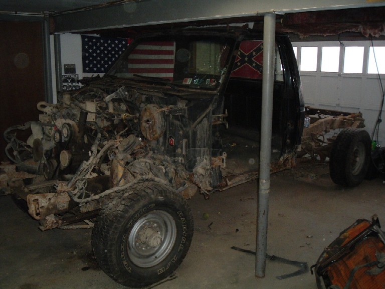 1989 Ford F-250 chassis with engine removed, in a garage