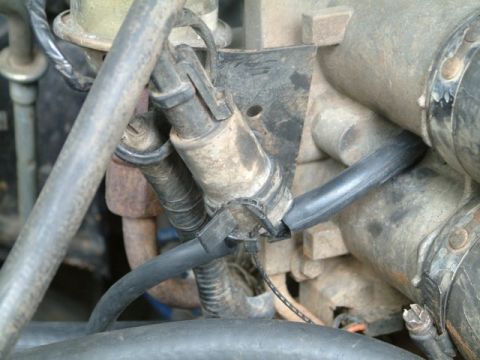 1992 Ford Bronco - This image shows a close-up view of various engine components and hoses, with visible dirt and wear.