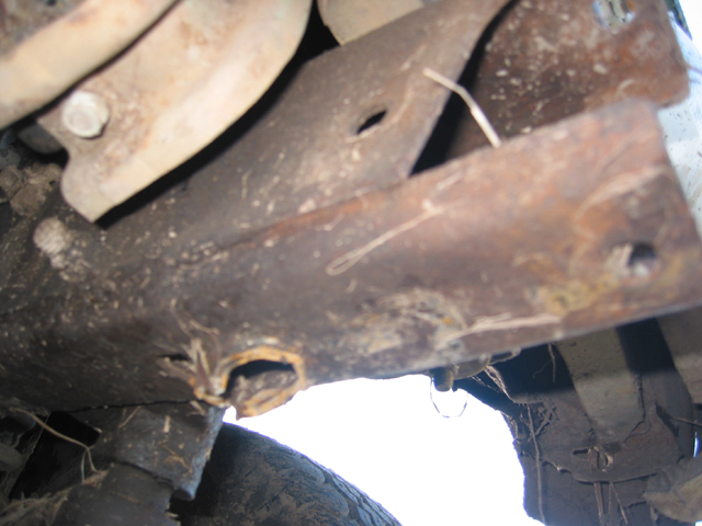 close-up of rusty metal parts and suspension components under a vehicle