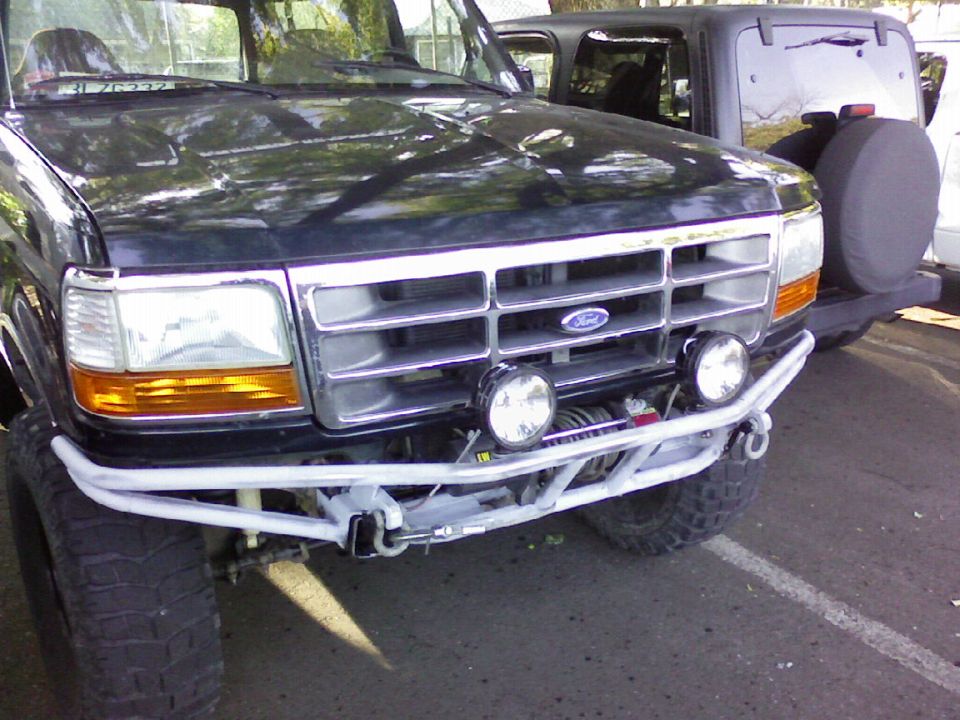 Front grille of lifted black Ford truck with tube bumper