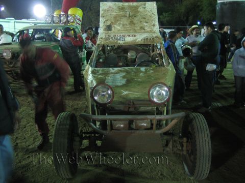 Front view of a dual-headlight off-road buggy with exposed engine at night