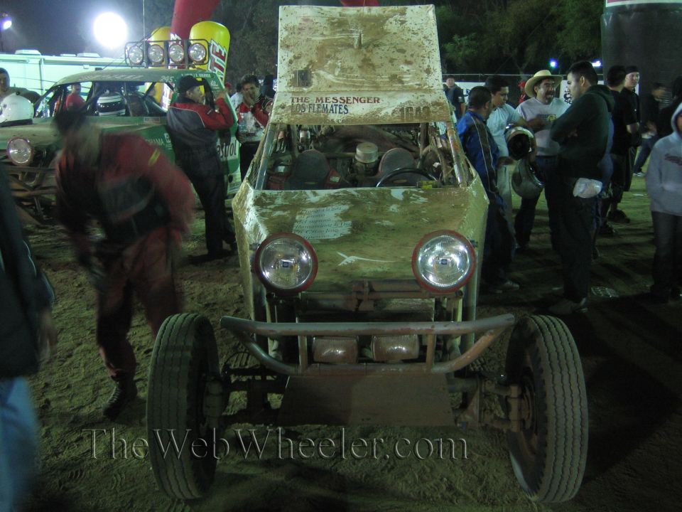 Front view of a dual-headlight off-road buggy with exposed engine at night