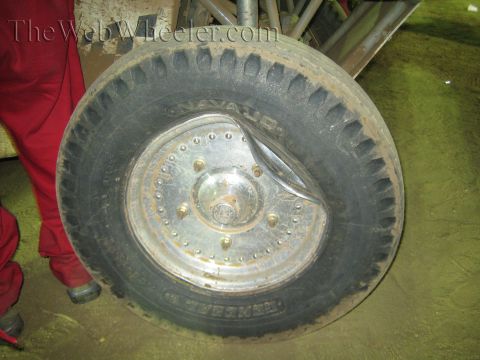 Close-up of a Navajo off-road tire on a riveted metal disc wheel