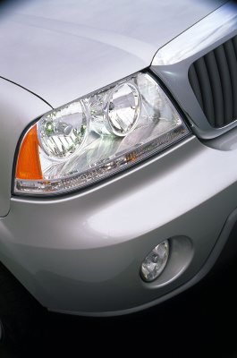 2003 Lincoln Aviator - Close-up of a silver SUV's front corner, showing the headlight and grille detail.