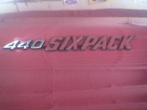 1988 Ford Bronco - A close-up of a 440 SIXPACK emblem on a red vehicle panel.