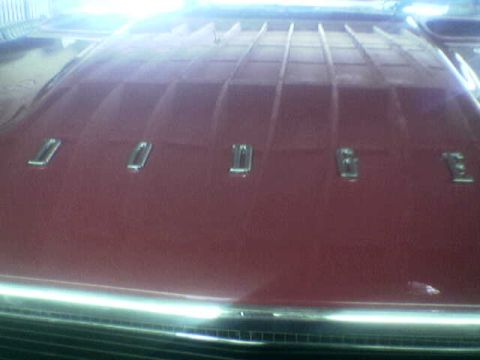 1988 Ford Bronco - The hood of a vehicle displays chrome lettering spelling out the brand name.