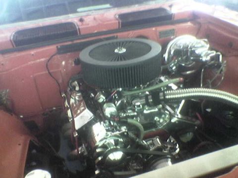 1988 Ford Bronco - Close-up view of a customized engine bay a prominent air filter and polished metal parts.