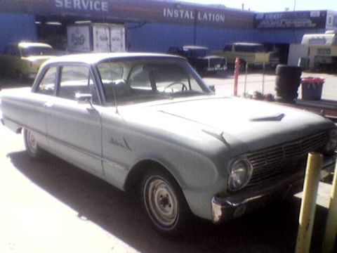 1988 Ford Bronco - This 1960 Ford Falcon sedan is seen in front of a service and installation building.