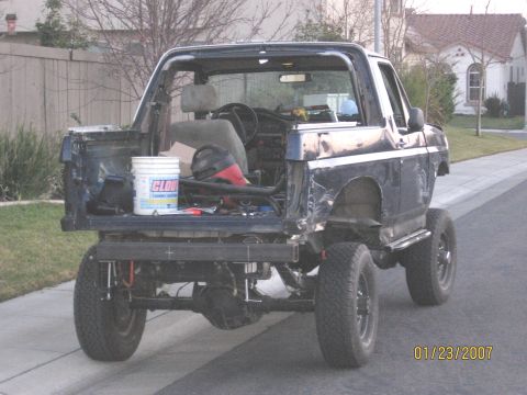 1994 Ford Bronco - This 1994 Ford Bronco is undergoing modifications, with its rear section open and a roll cage visible.