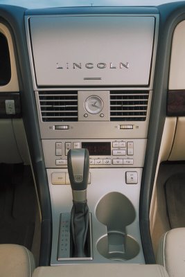 2003 Lincoln Aviator - Interior view of a vehicle's center console, the Lincoln brand name and climate controls.