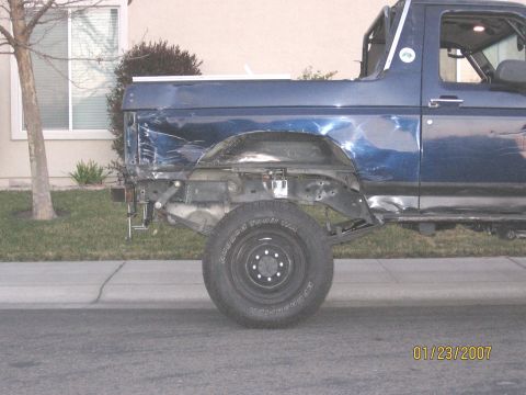 1994 Ford Bronco - Rear view of a damaged 1994 Ford Bronco, missing its tailgate and rear bumper.