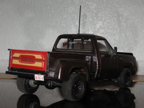 1977 Ford F-150 - Model pickup truck with a custom tailgate and rifles displayed in the cab's rear window.