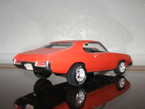 1977 Ford F-150 - Model car with a reflective surface and a white background.