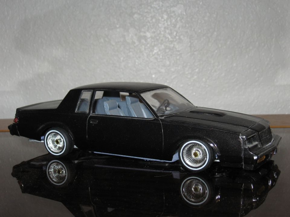 Black model car with wire wheels and blue interior