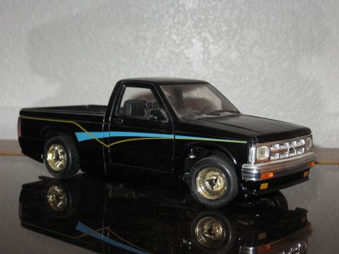 1977 Ford F-150 - Model pickup truck with custom stripe detail and gold wire wheels.
