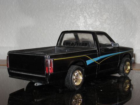 1977 Ford F-150 - Model pickup truck with 'GOOD YEAR' text on headrests and custom stripe graphics.