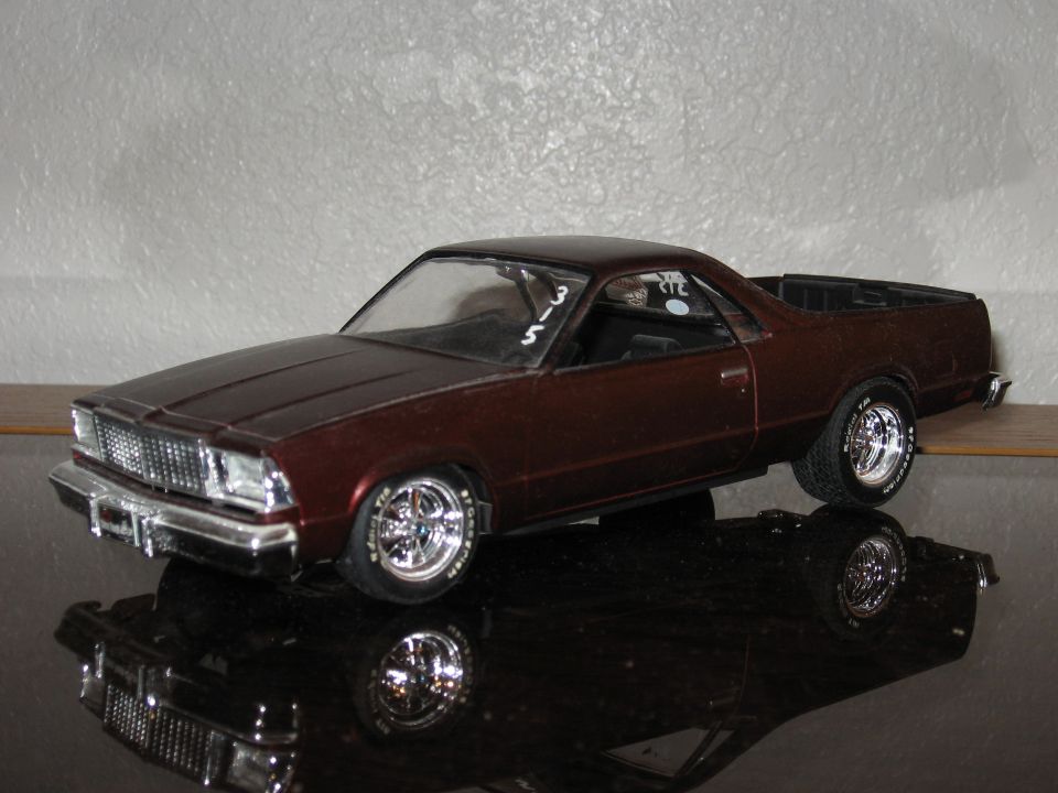 Model car, dark red, 3/4 front view. Numbers '315' on windshield
