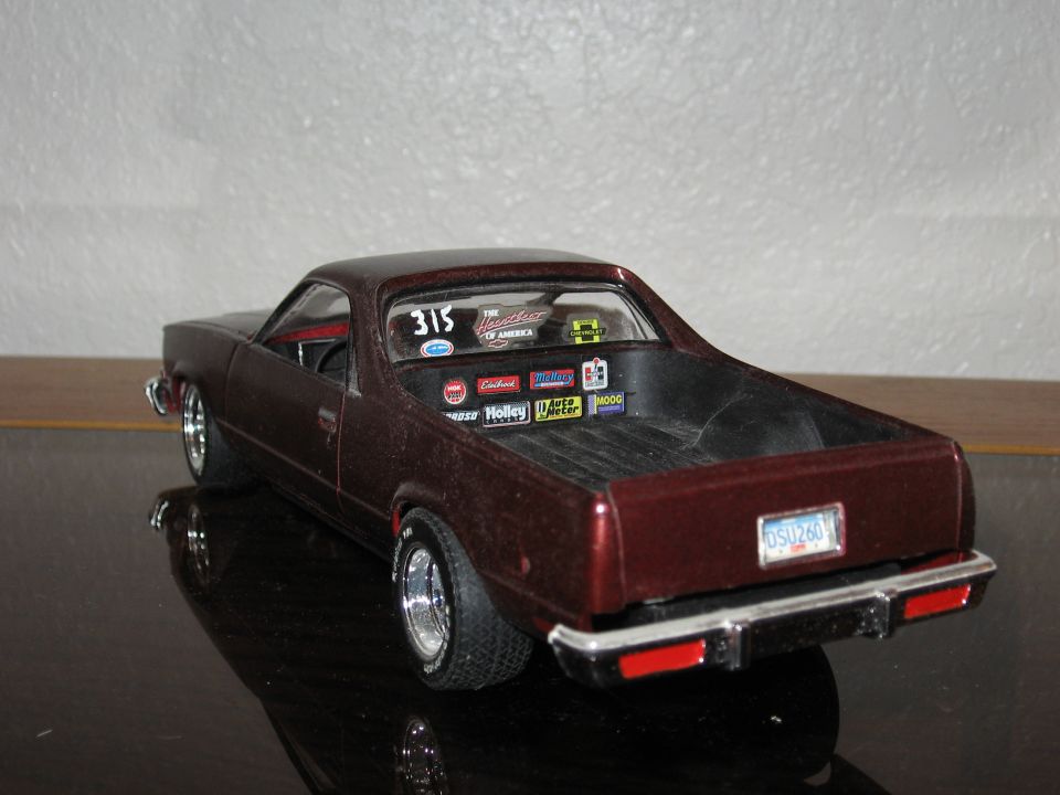 Model car with racing stickers on rear window and bed. License plate reads OSU260