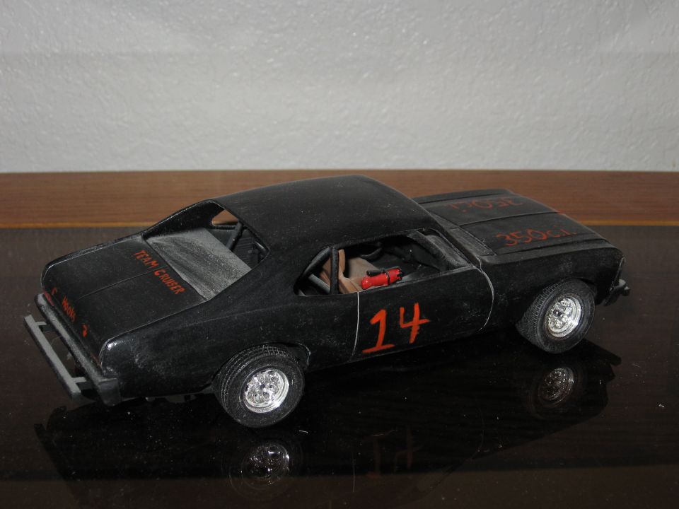 Black model car with red number 14 on the side and 'TEAM CRUISER' on the trunk