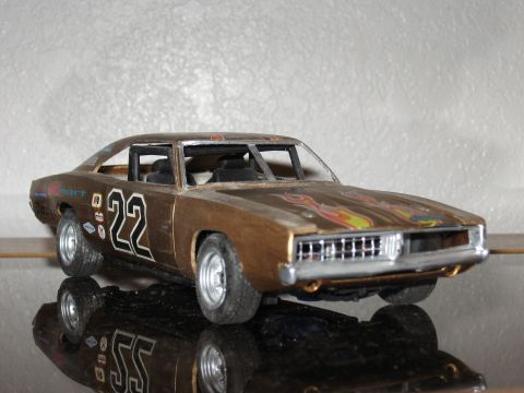 1977 Ford F-150 - This model car features a gold paint job with flame decals and the number 22 prominently displayed.