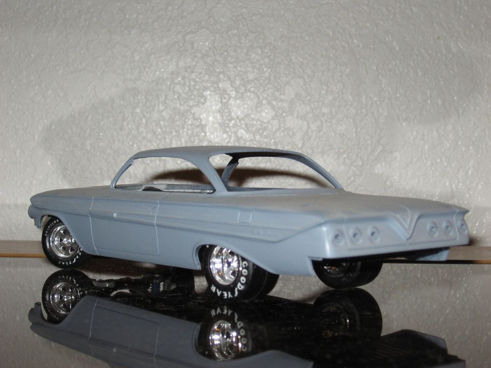 Gray model car, 3/4 front view, with Goodyear tires