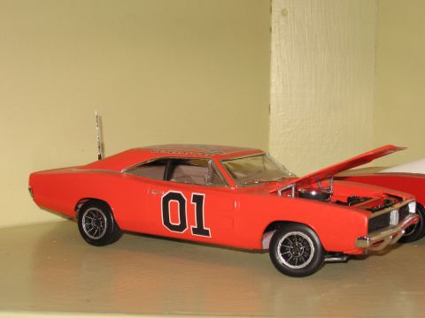 1977 Ford F-150 - A model of the General Lee car is shown with its hood up, next to another vehicle.