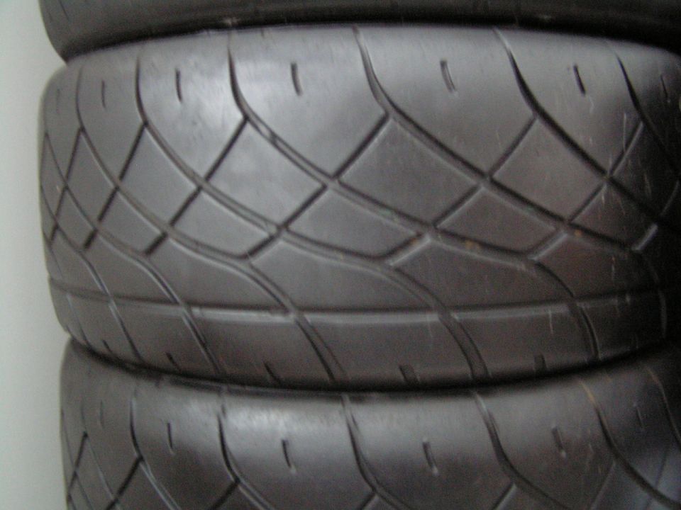 Stack of two black tires with a diamond tread pattern