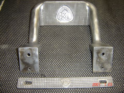 1993 Ford Bronco - Close-up of two metal step plates, one U-shaped and one flat, each a triangular emblem.