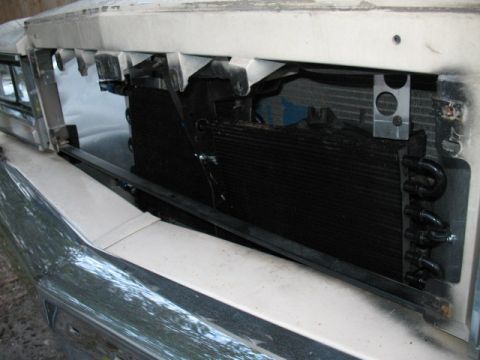 1985 Ford LTD Crown Victoria - Close-up view of the front grille and radiator assembly of a vehicle, showing the internal components.