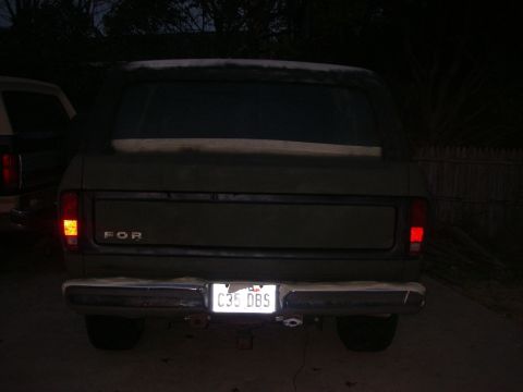 1978 Ford Bronco - Rear view of a 1978 Ford Bronco, with another vehicle to its left.